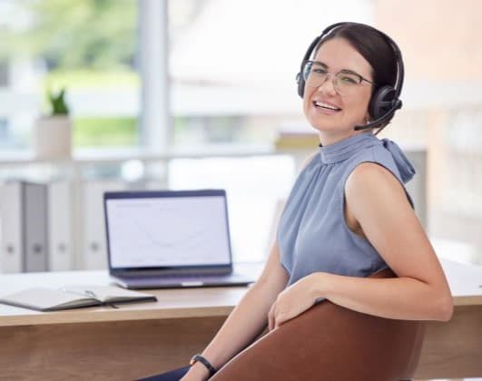 Smiling brunette female receptionist.