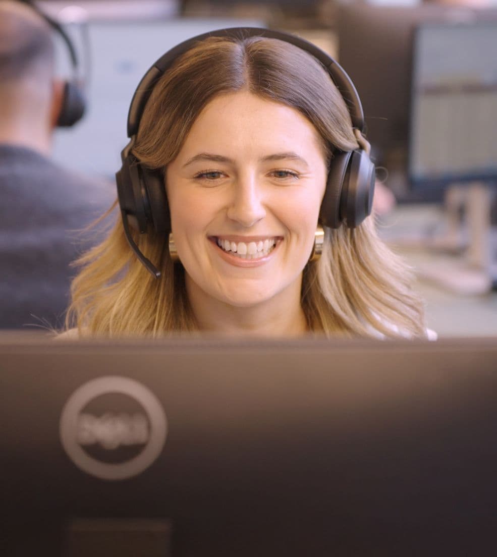 Smiling female Telephone Answering Specialist receptionist answering the call with great customer service.