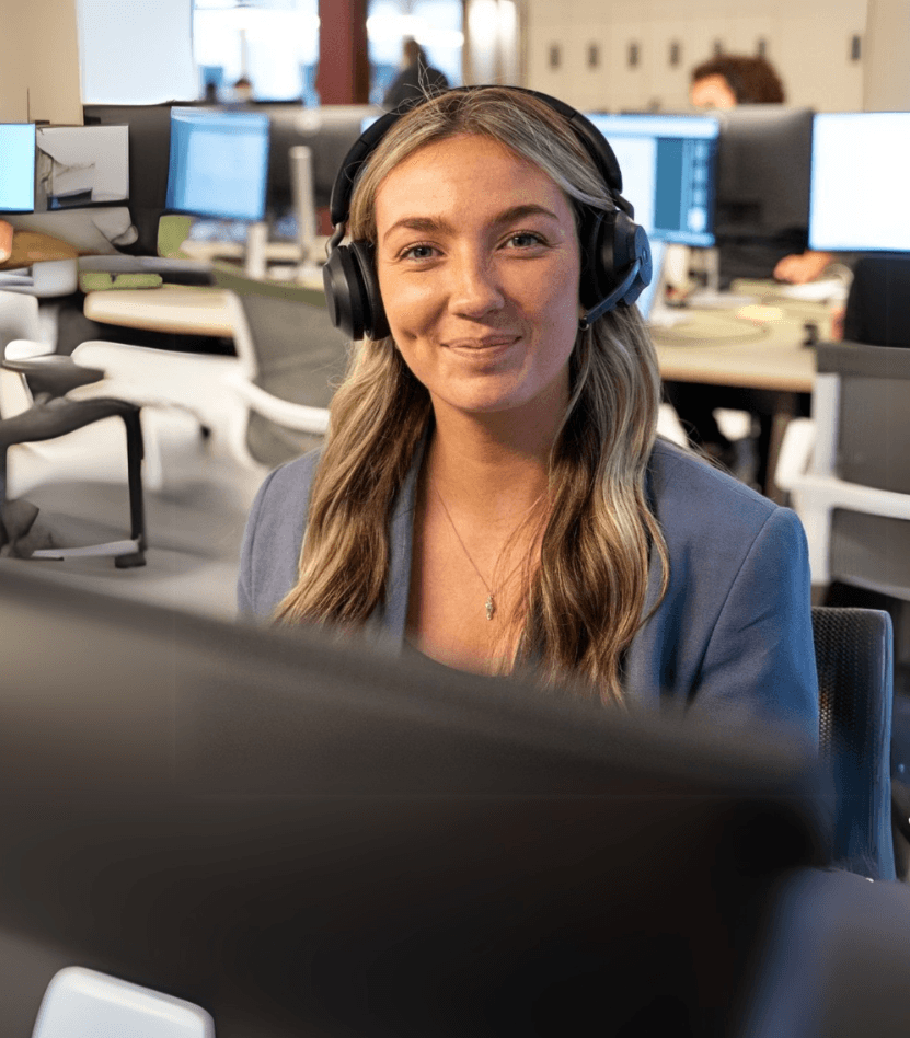 Blonde telephone answering specialist wearing a headset providing great customer service.